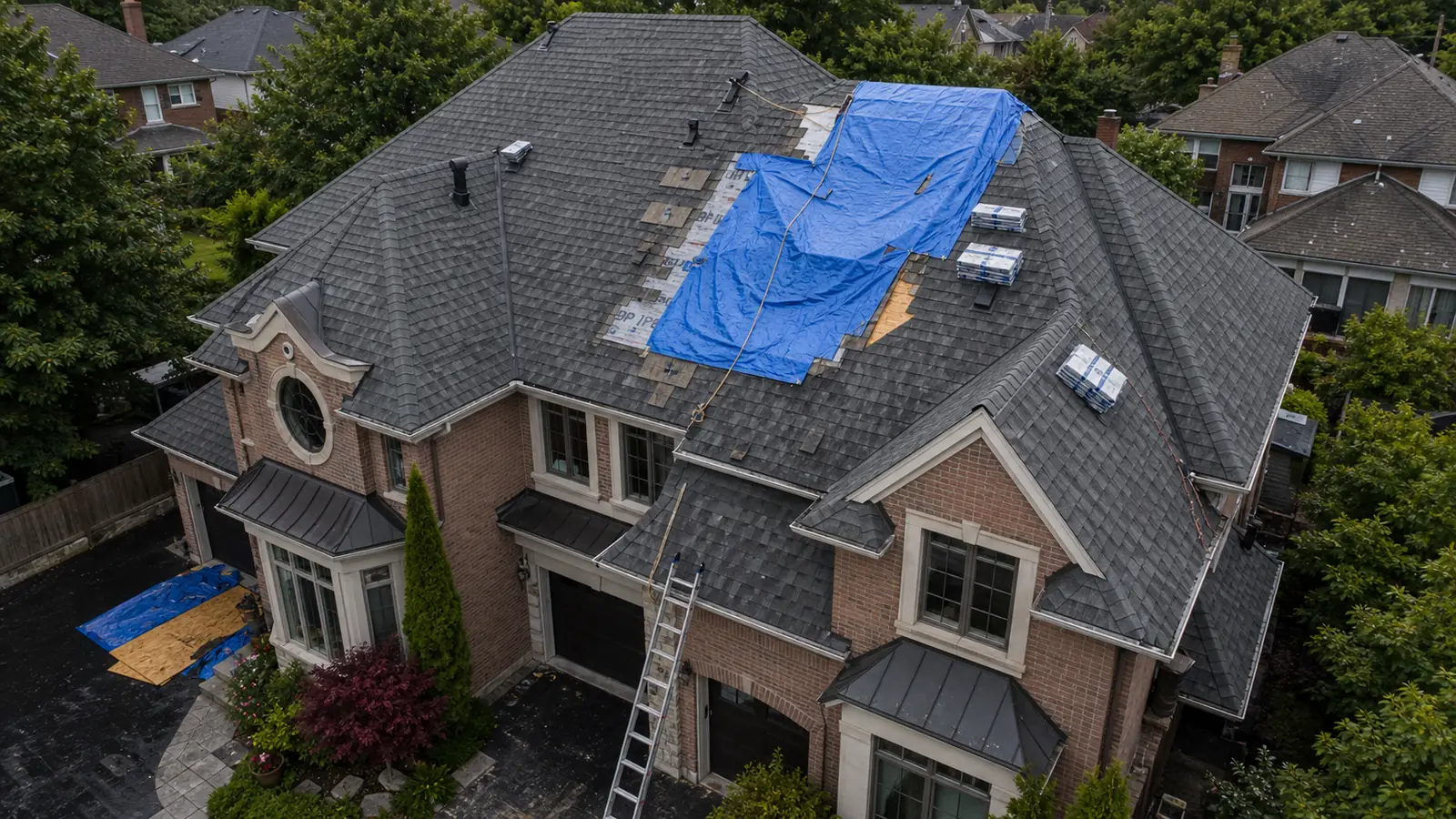 Emergency roof repair Toronto — tarping over storm-damaged roof